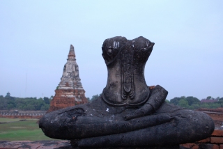 Scattered about the ruined wats, headless Buddhas bore testimony to the sad end of an ancient city