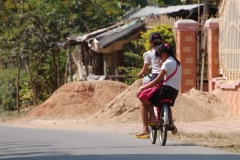 Cycling to school. Unlike England with its one-per-car commuters, every mode of transport in Asia is shared